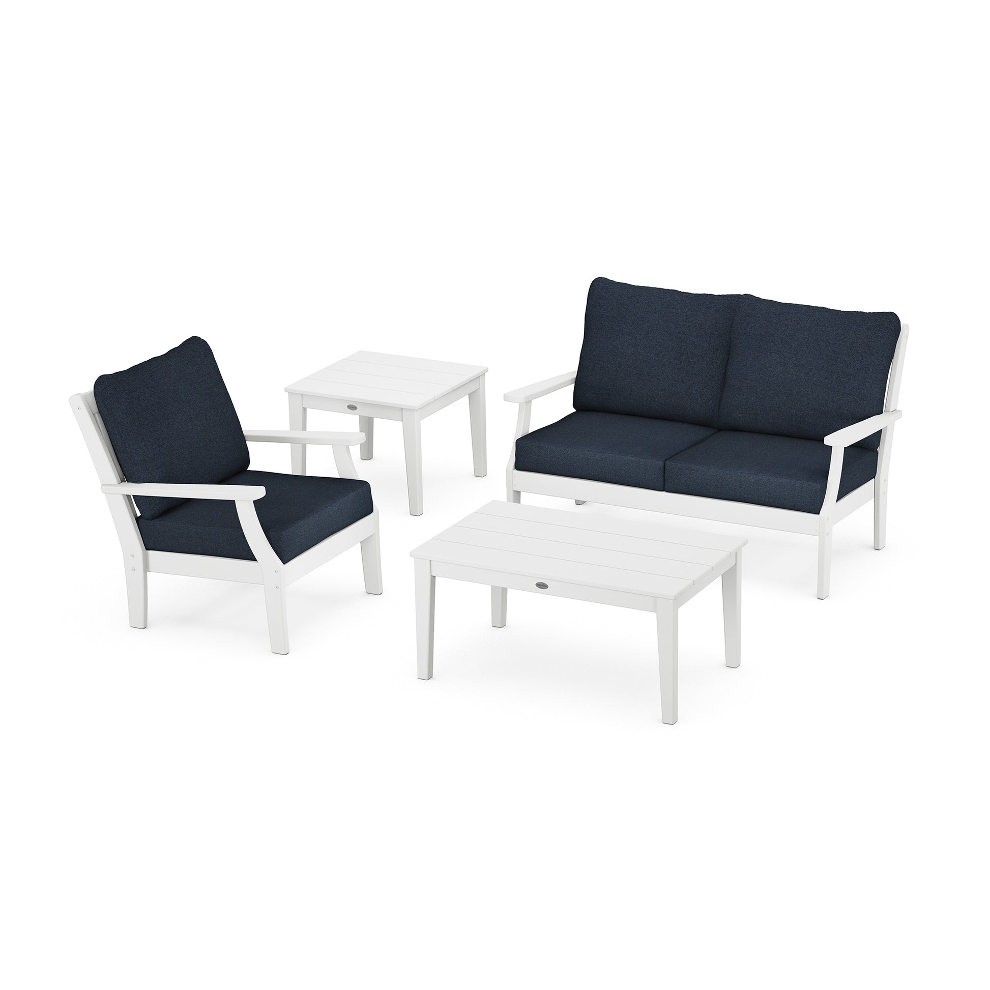 A modern POLYWOOD® Braxton 4-Piece Deep Seating Set including a white sofa, two chairs with navy blue cushions, and two white square tables, arranged on a plain white background.