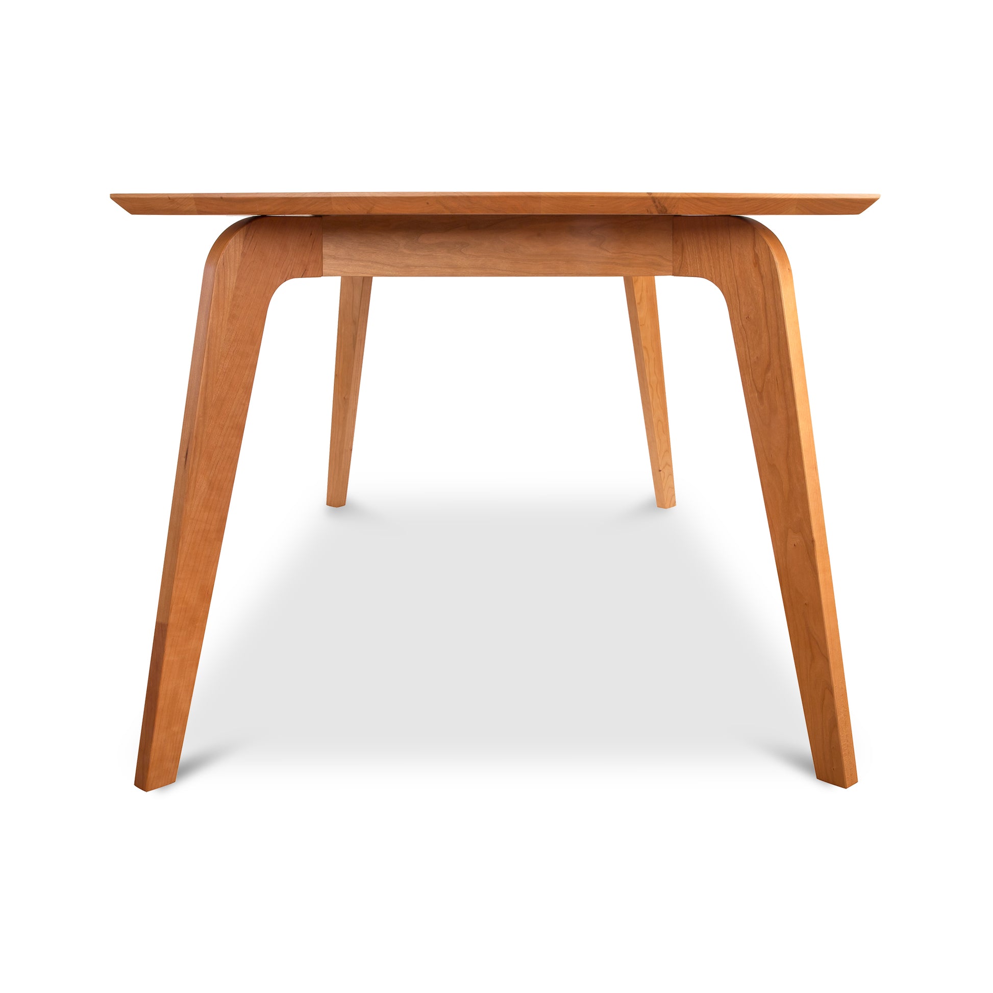 Brighton Solid-Top Dining Table by Lyndon Furniture with a rectangular wood top and angled legs, showcasing mid-century modern craftsmanship.