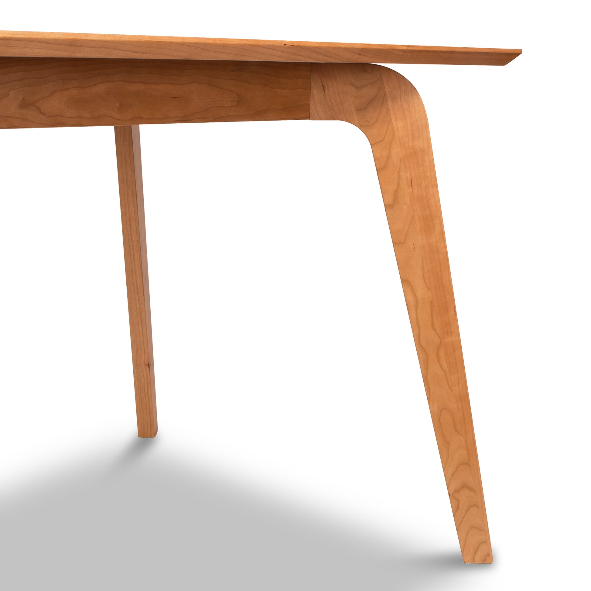 Brighton Solid-Top Table by Lyndon Furniture, featuring distinctive angled, curved mid-century modern legs and rich wood craftsmanship.
