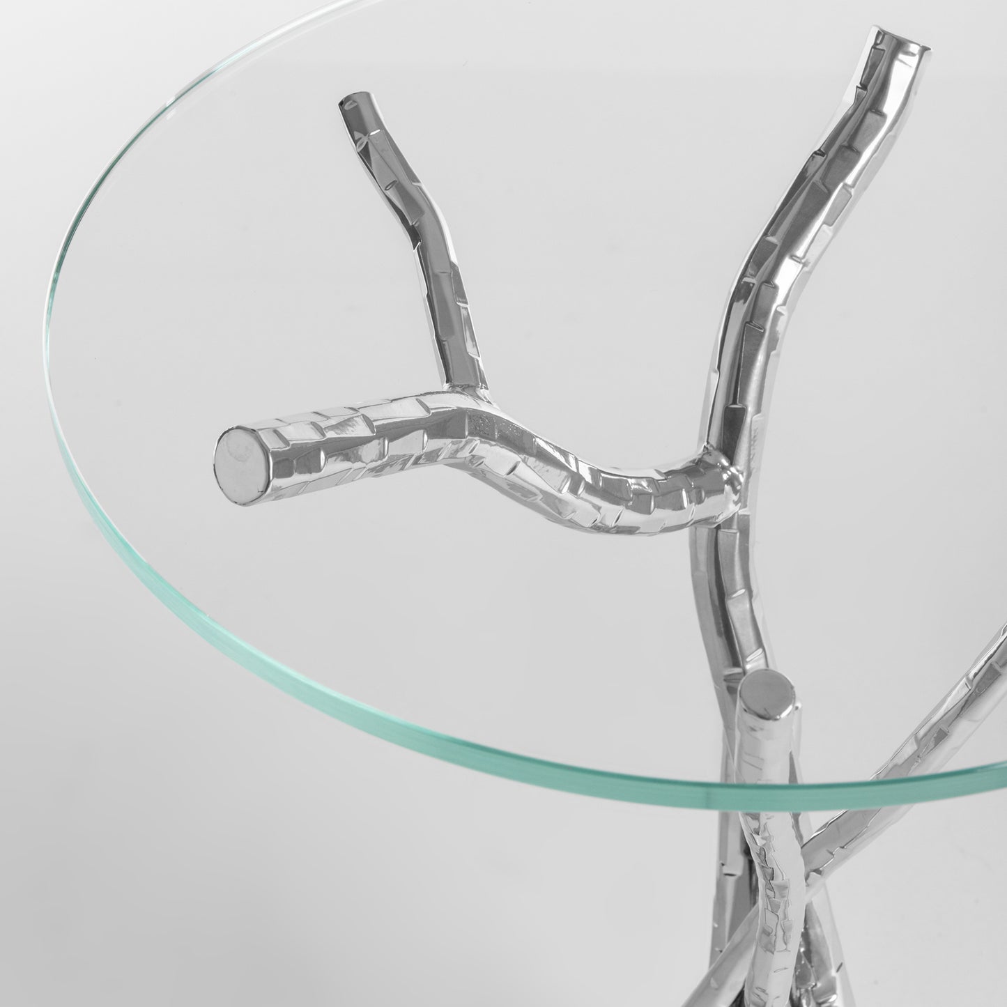 Brindille Accent Table by Hubbardton Forge with tempered glass top and unique silver branch-like metal legs for sturdy support.