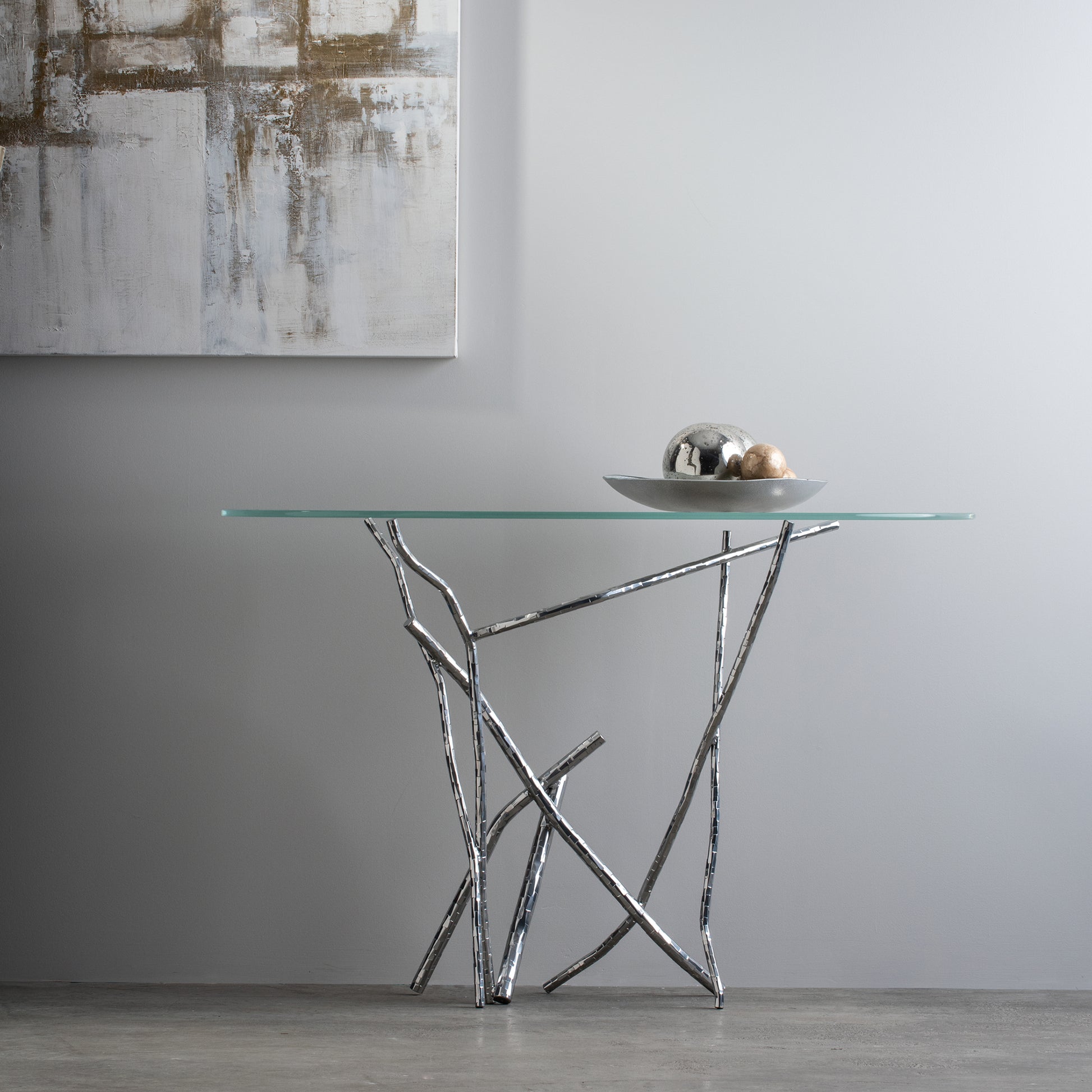 The Hubbardton Forge Brindille Console Table is a Hubbardton Forge Brindille Console Table featuring elegant branches adorning its glass surface.