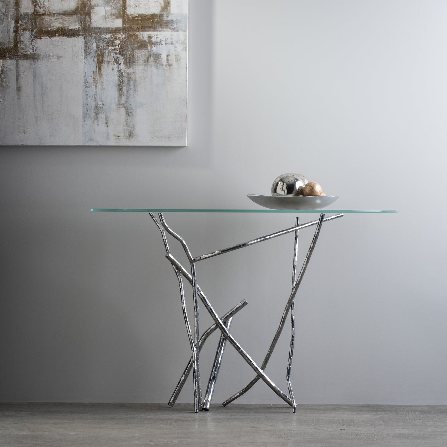 Hand-hammered silver base and metallic spheres of the Hubbardton Forge Brindille Console Table.