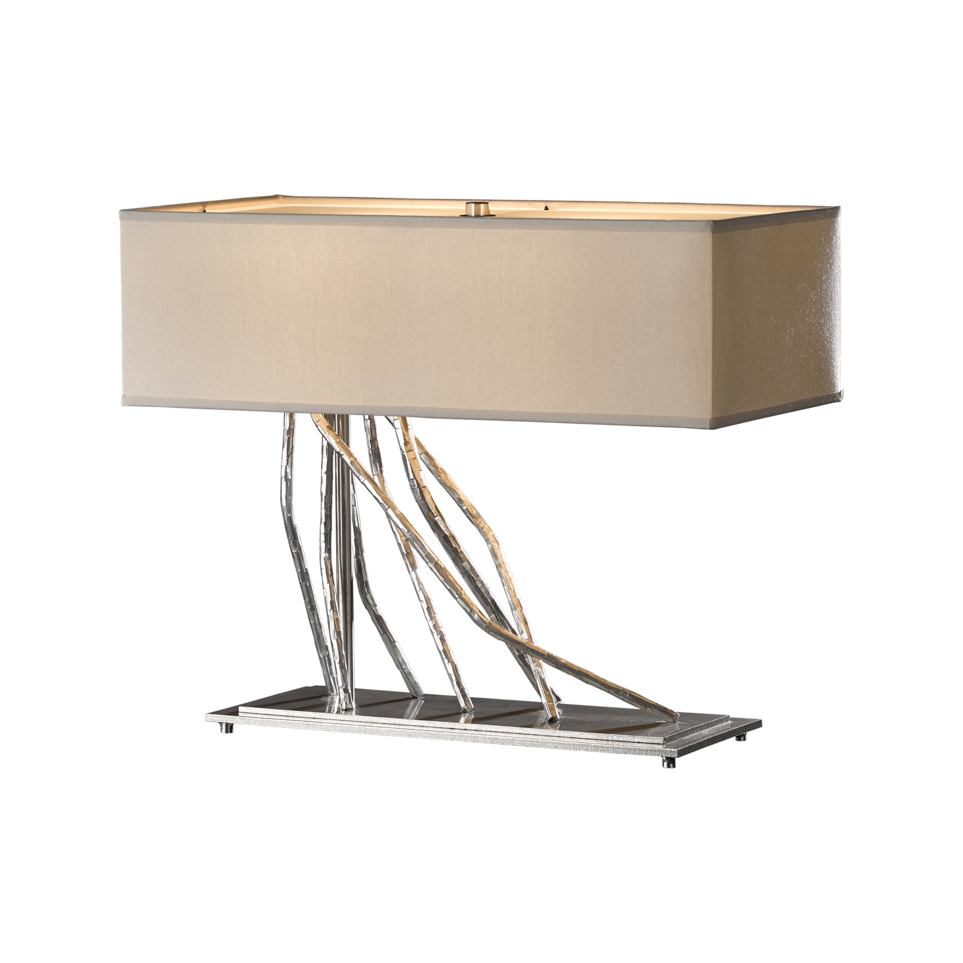 A modern Brindille Table Lamp by Hubbardton Forge, featuring a rectangular beige shade on top of a chrome base with elegantly twisted iron rods supporting it.
