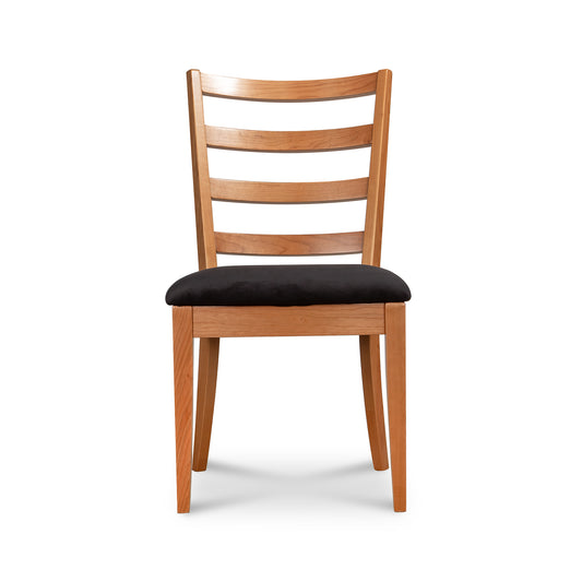 Bromley Ladder-Back Chair by Vermont Woods Studios with natural wood frame and black upholstered seat, highlighting craftsmanship and design.