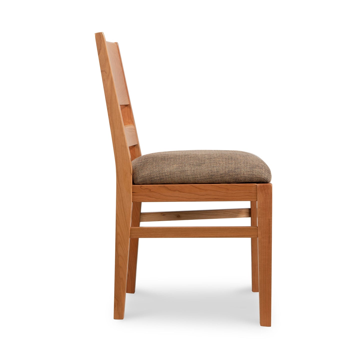 A wooden dining chair with a tan upholstered seat.