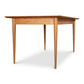 A Burke Modern Dining Table made of solid wood, with two legs, on a white background from Vermont Woods Studios.