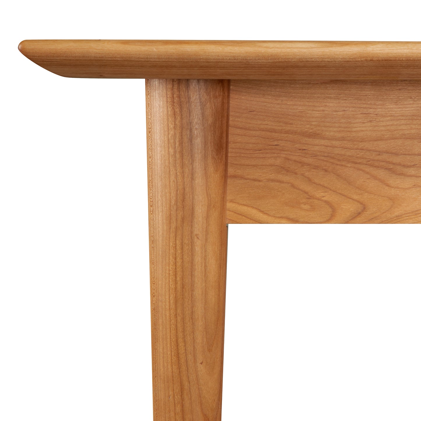 A close up of the Burke Modern Dining Table by Vermont Woods Studios, showcasing its craftsmanship.
