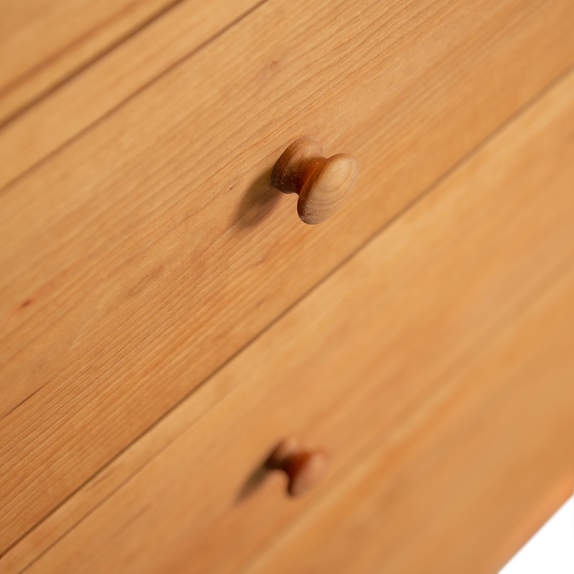Detail of two solid wood drawers with round knobs on the Burlington Shaker 6-Drawer Chest, handcrafted by Vermont Furniture Designs.