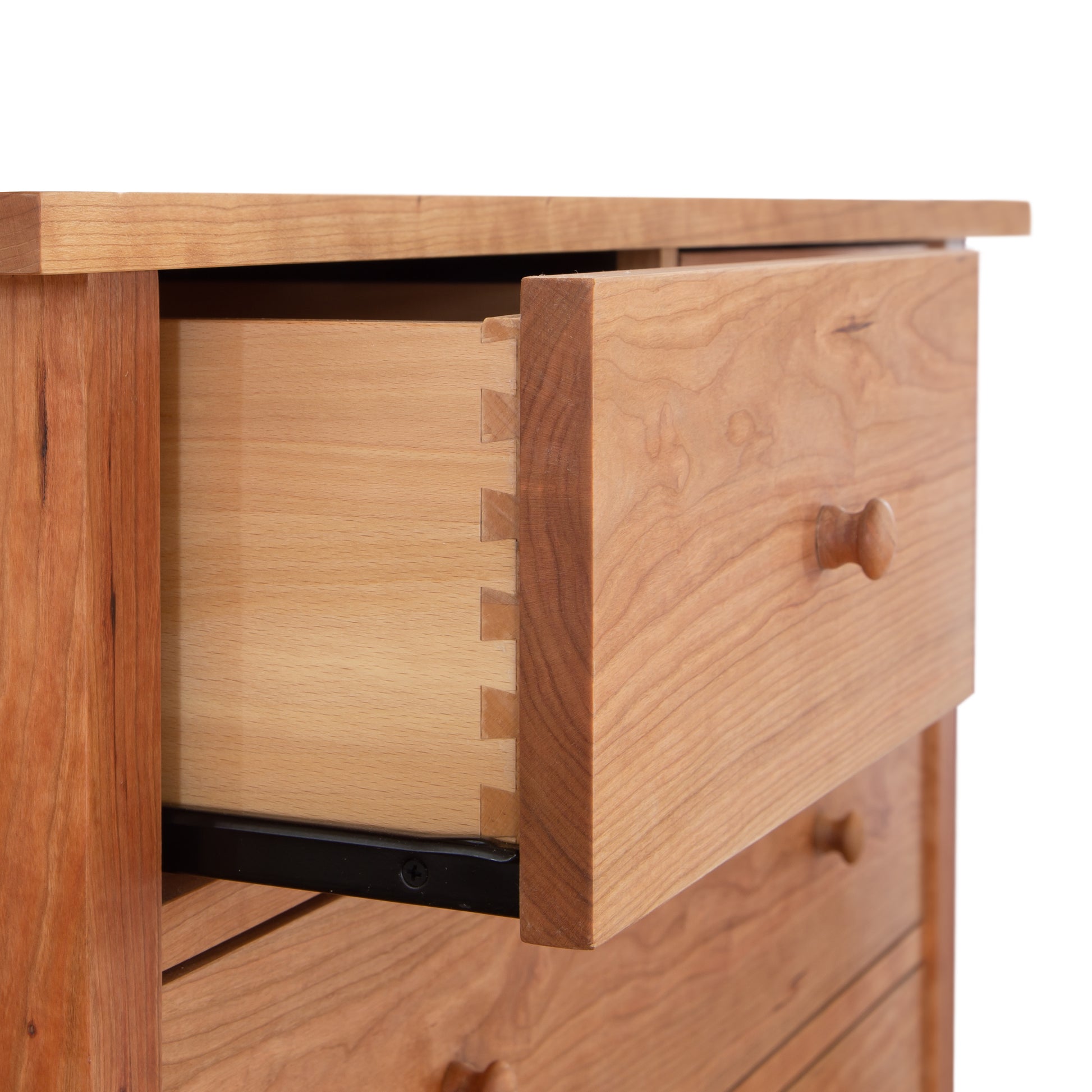 A Vermont Furniture Designs Burlington Shaker 7-Drawer Chest partially opened, revealing dovetail joints and a smooth interior finish.