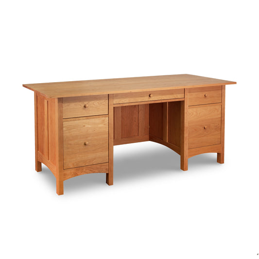 A Vermont Furniture Designs Burlington Shaker Executive Desk with multiple drawers and a cabinet, isolated on a white background.