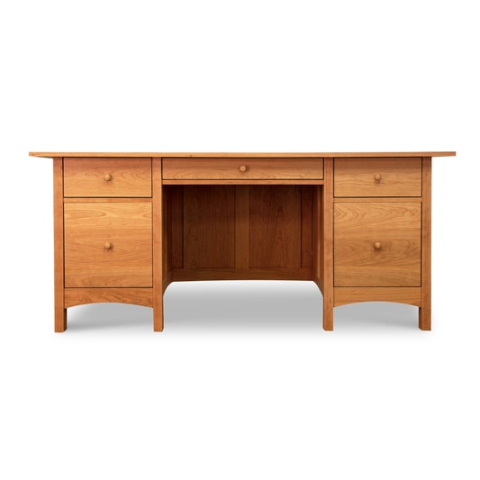 Burlington Shaker Executive Desk in solid wood with a smooth surface, central drawer, and two sets of side drawers with round knobs by Vermont Furniture Designs.