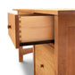 A Vermont Furniture Designs Burlington Shaker Study Desk with an open drawer featuring dovetail joints, isolated on a white background.