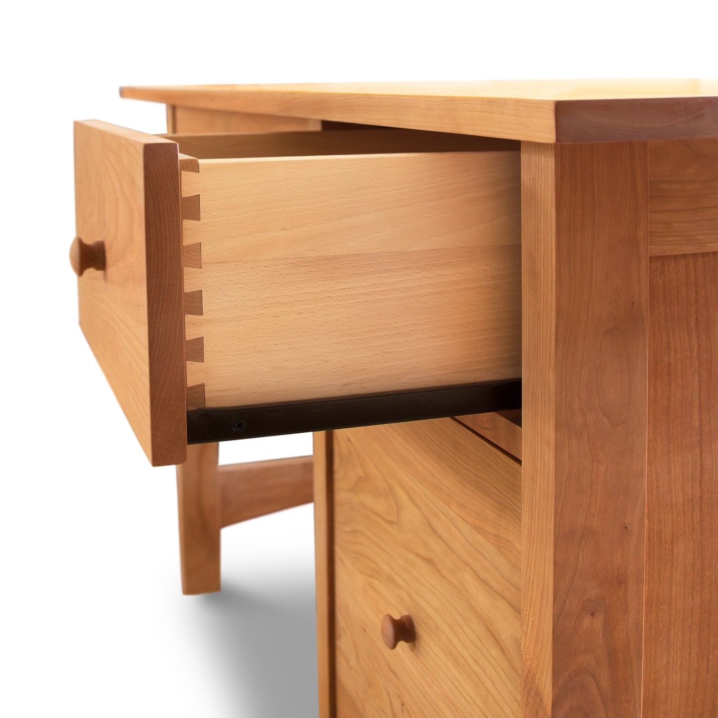 A Vermont Furniture Designs Burlington Shaker Study Desk with an open drawer featuring dovetail joints, isolated on a white background.