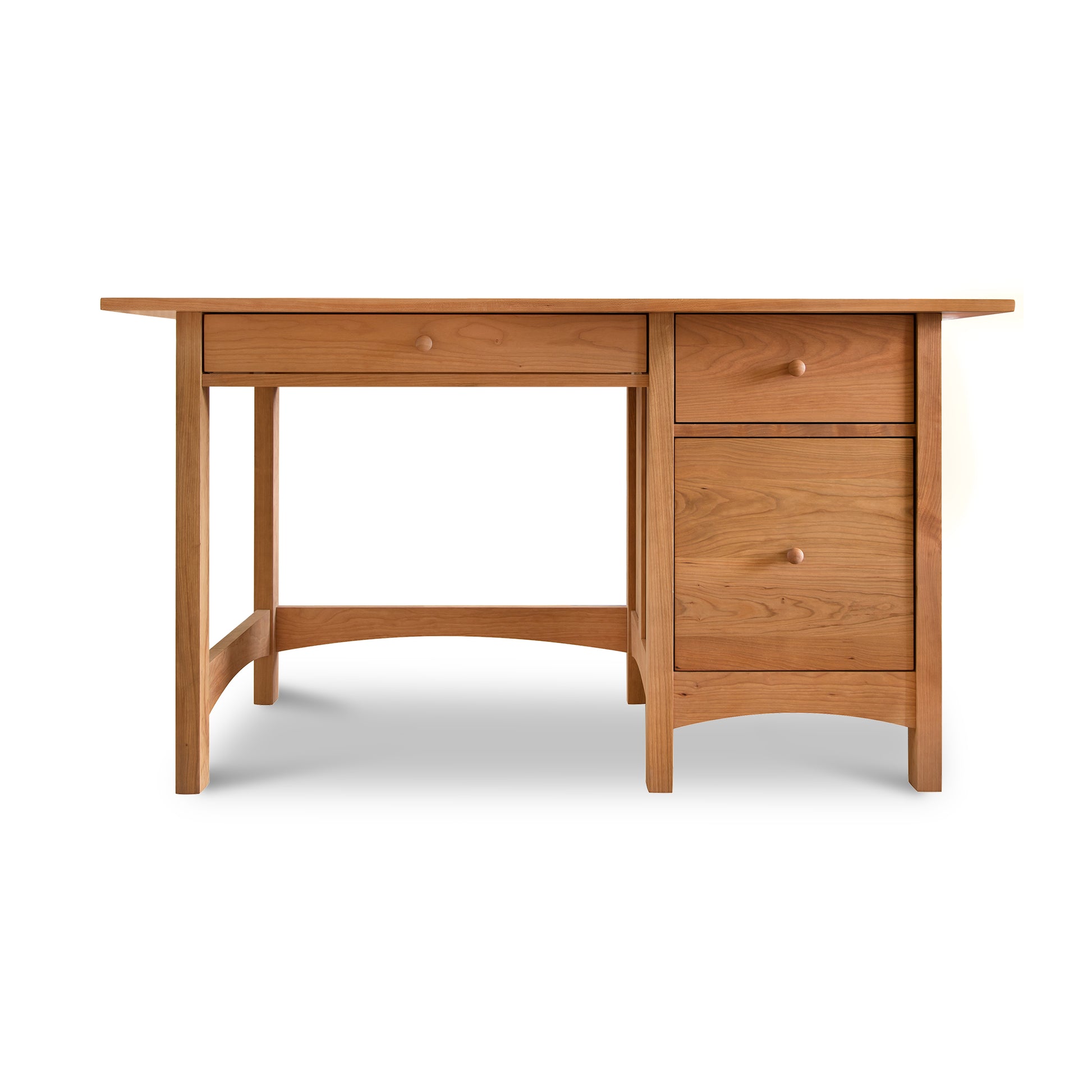 A Burlington Shaker Study Desk by Vermont Furniture Designs, with drawers on one side, isolated on a white background.