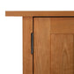A close-up view of a solid wood, Vermont Furniture Designs Burlington Shaker Tall Storage Chest door with a visible metal hinge.