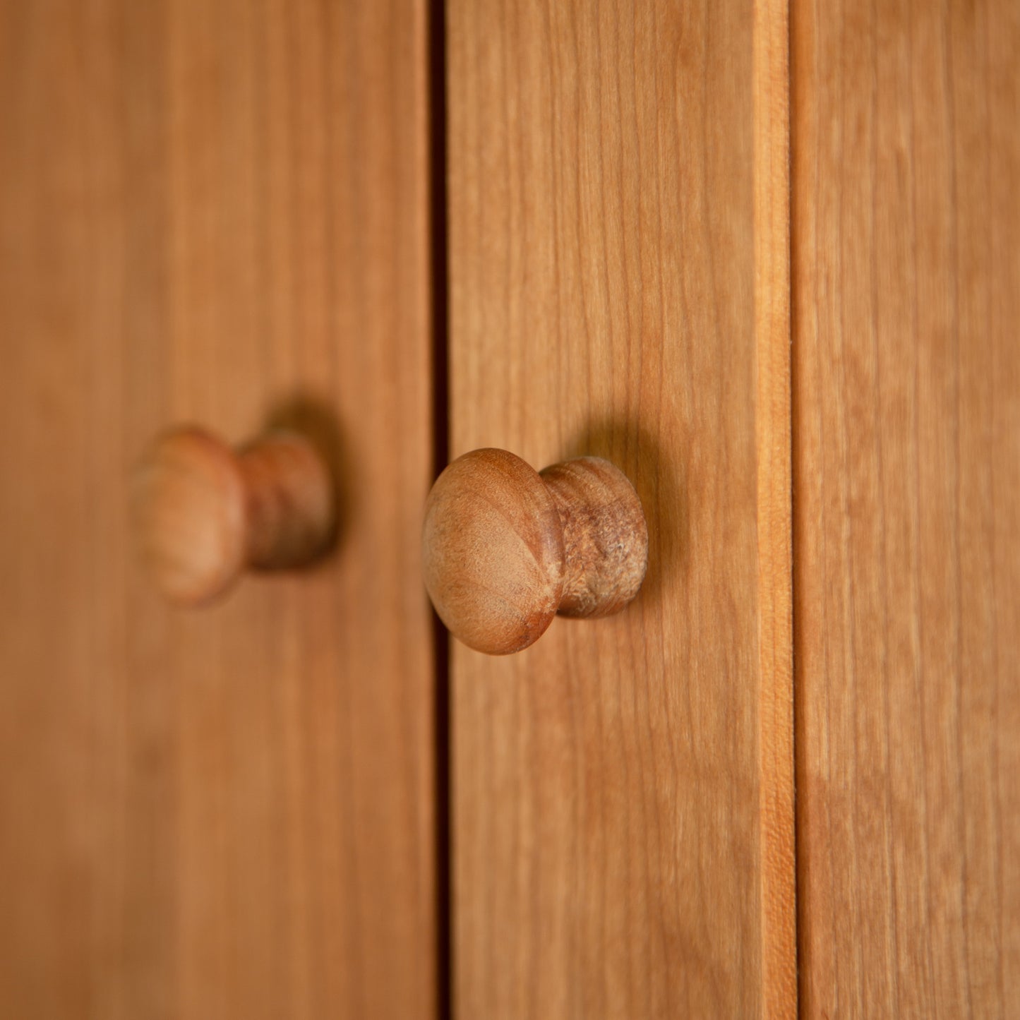 Burlington Shaker Tall Storage Chest by Vermont Furniture Designs, highlighting natural wood grain and round knobs on the doors.