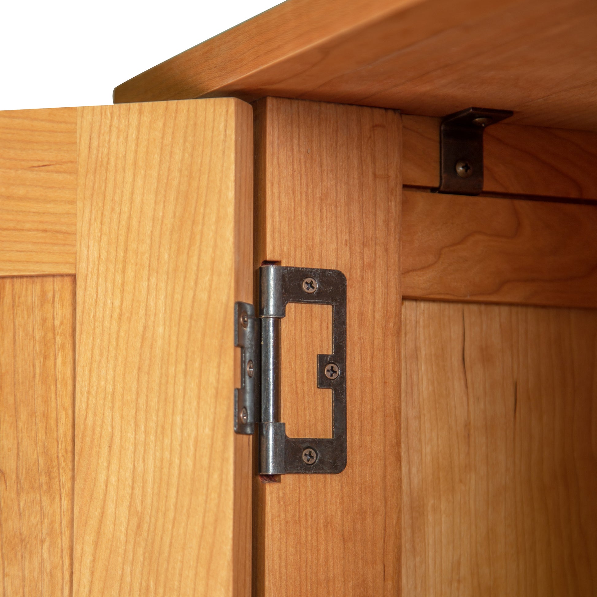 Detail of the sturdy metal hinge on the Burlington Shaker Tall Storage Chest, showcasing quality craftsmanship and solid American-made construction.