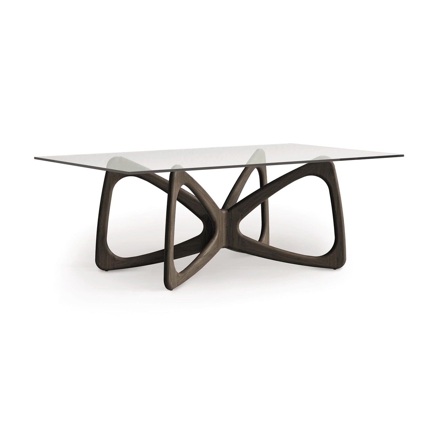 Butterfly Glass Top Dining Table by Copeland Furniture with sculptural hardwood base and rectangular tempered glass top, showcasing elegant craftsmanship.