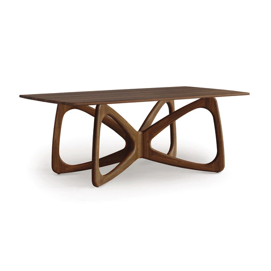 Butterfly Solid Top Dining Table by Copeland Furniture with a sculptural curved hardwood base, highlighting its elegant craftsmanship.