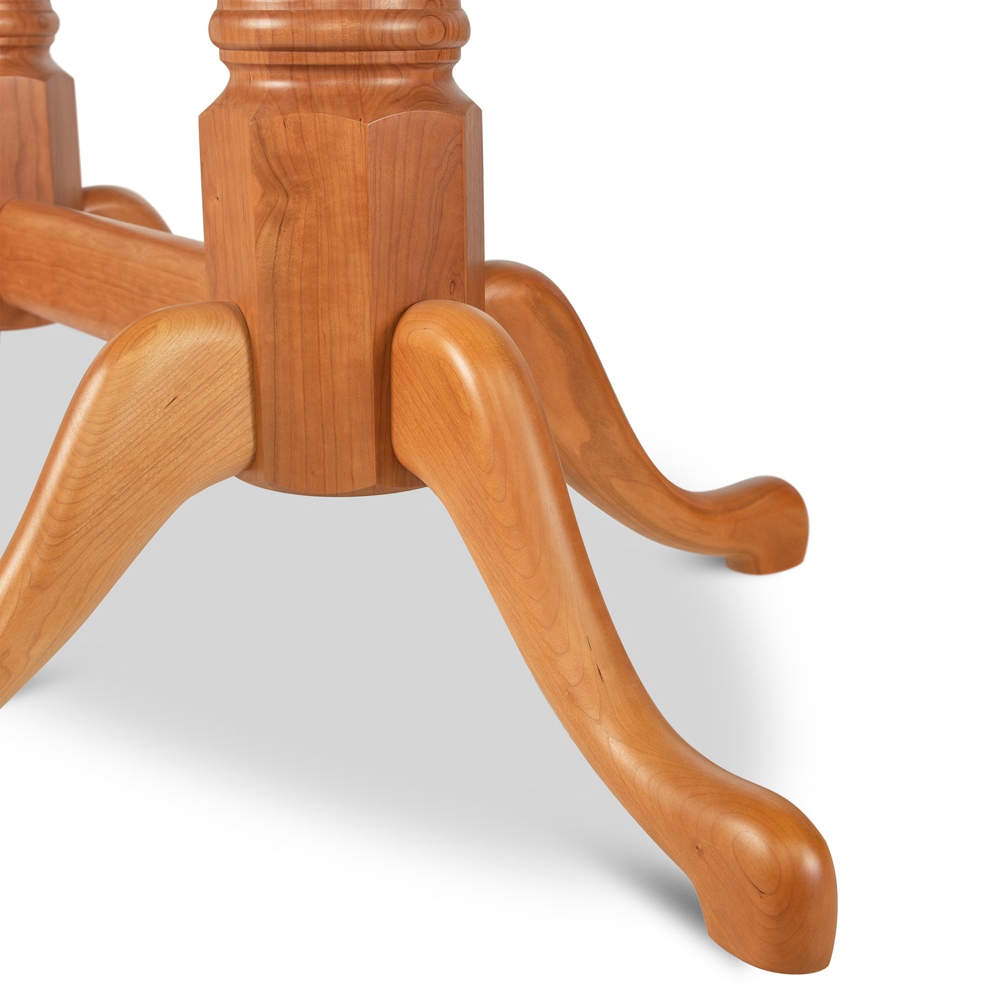A modern wooden table with Lyndon Furniture's Cabriole Oval Double Pedestal Solid Top Table feet.