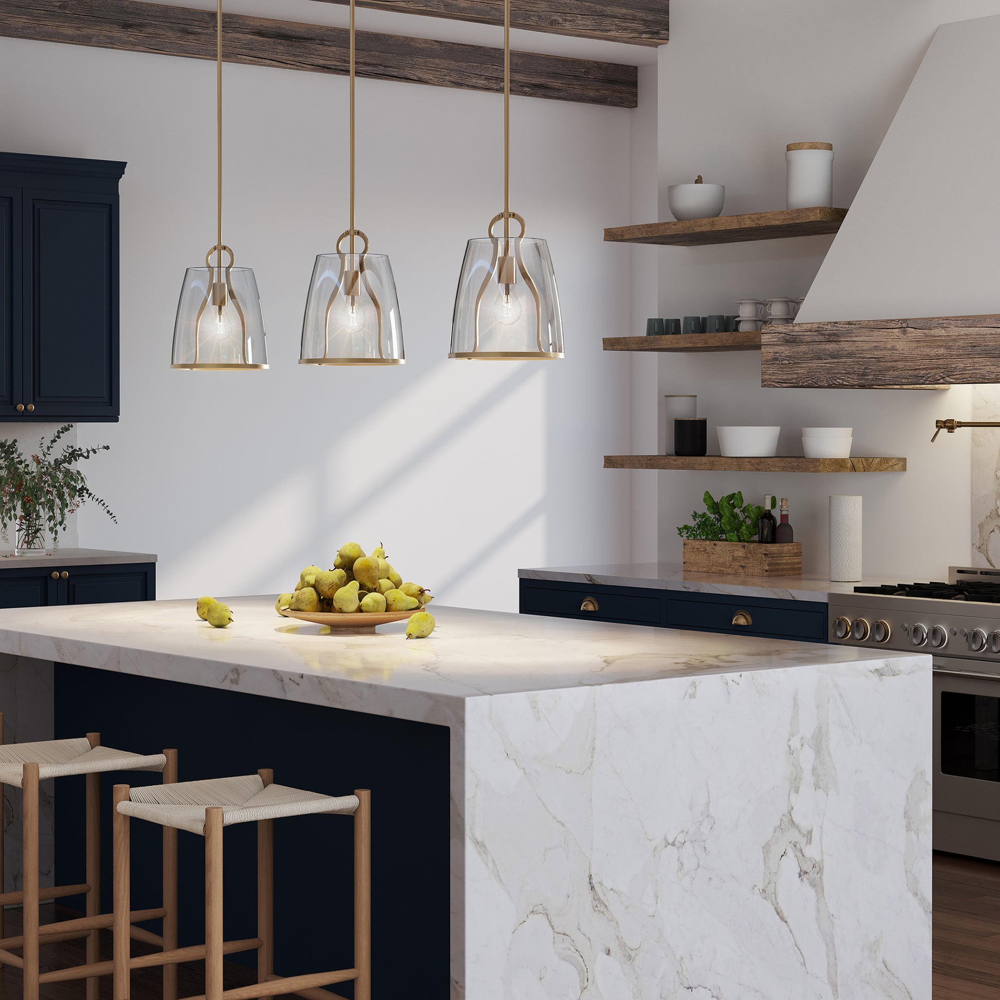A kitchen with blue cabinets and marble counter tops featuring an industrial metal Caliper Pendant from Hubbardton Forge.