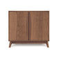 A Copeland Furniture Catalina 2-Door Buffet crafted from sustainable hardwoods, with two doors on angled legs, isolated against a white background.
