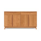 Modern solid wood sideboard with closed doors and tapered legs on a plain background, handcrafted in Vermont as part of the Copeland Furniture Catalina Buffet collection.