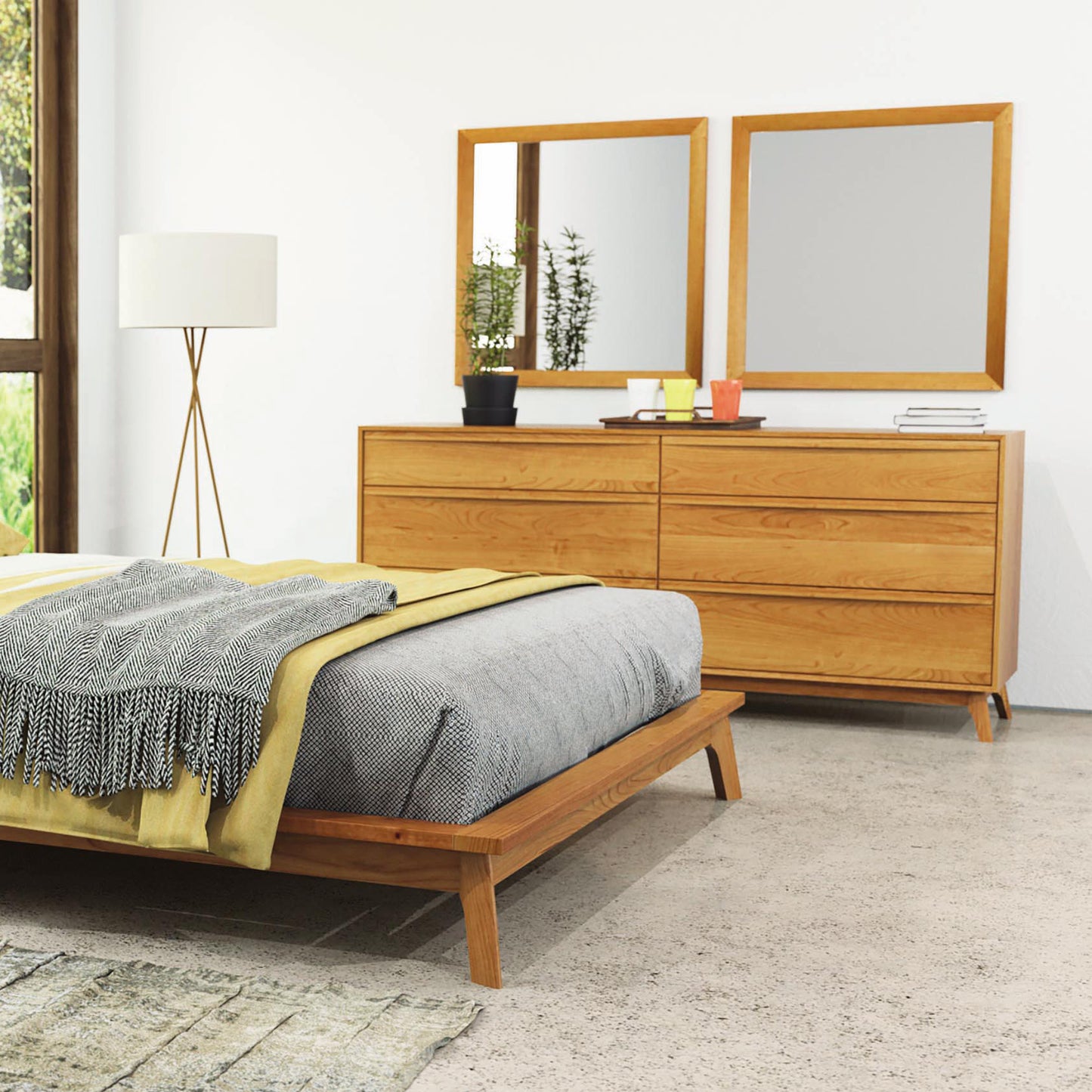 Copeland Furniture Catalina 6-Drawer Dresser in solid hardwood, featured alongside a wooden bed with gray bedding and subtle yellow accents.