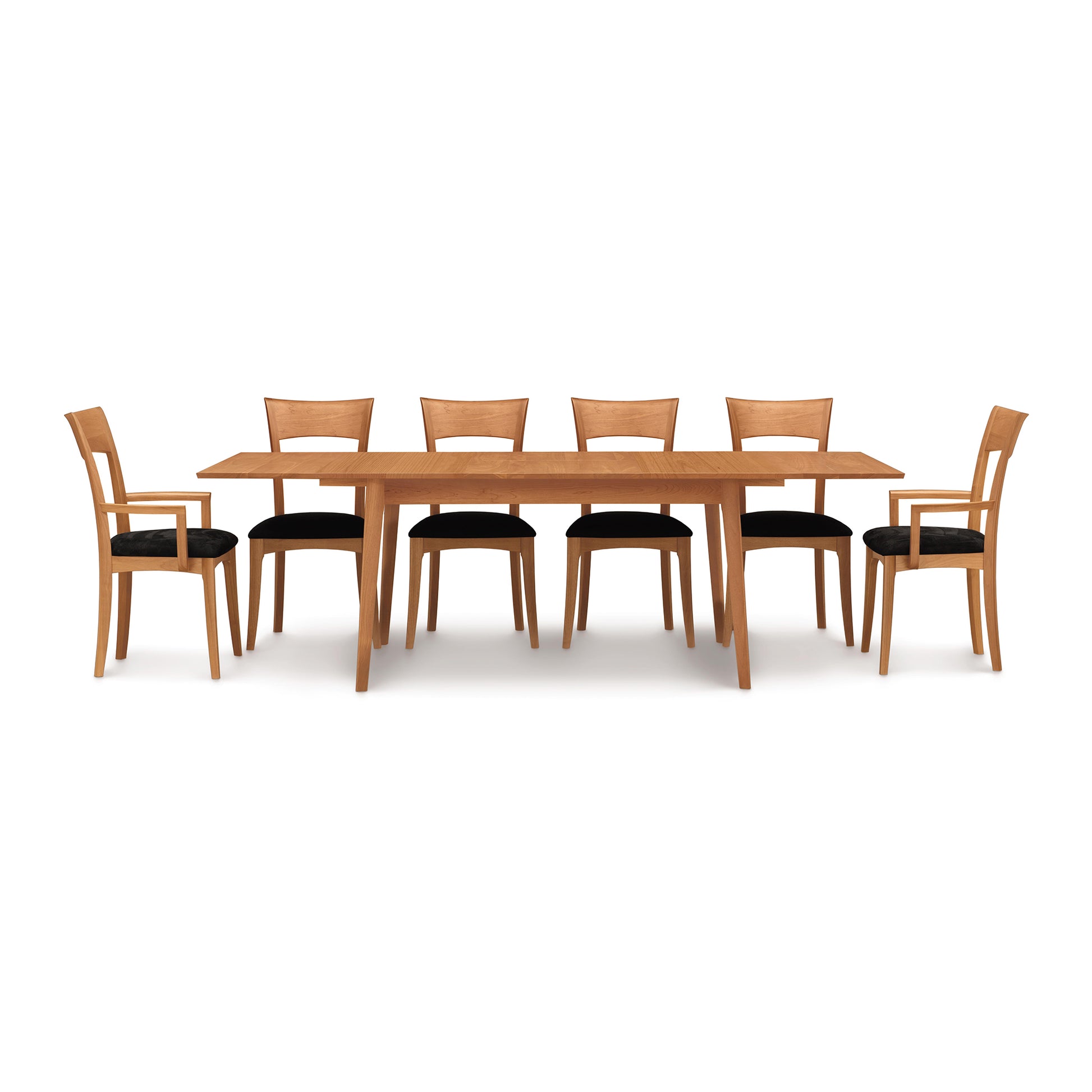 Copeland Catalina Extension Table with six matching wooden chairs featuring black cushioned seats, all crafted in high-quality wood.