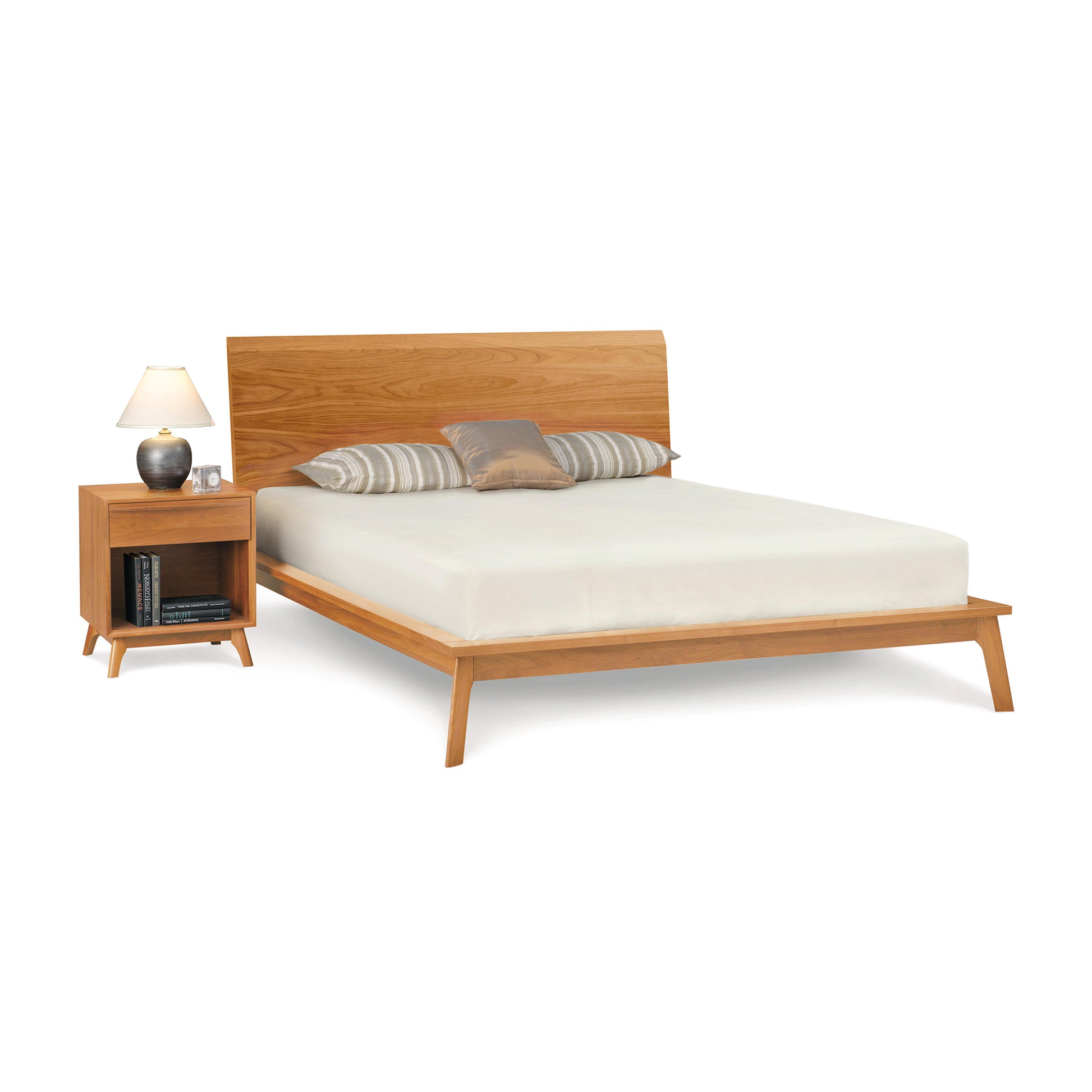 A modern Copeland Furniture Catalina Cherry Platform Bed frame made of solid natural cherry hardwood, with a matching nightstand and a neutral-colored bedding set.