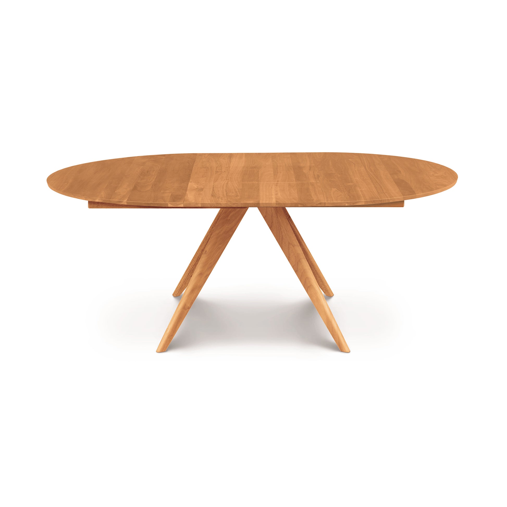 Catalina Round Extension Table by Copeland Furniture made of solid North American wood with angled legs, highlighting its elegant modern design.