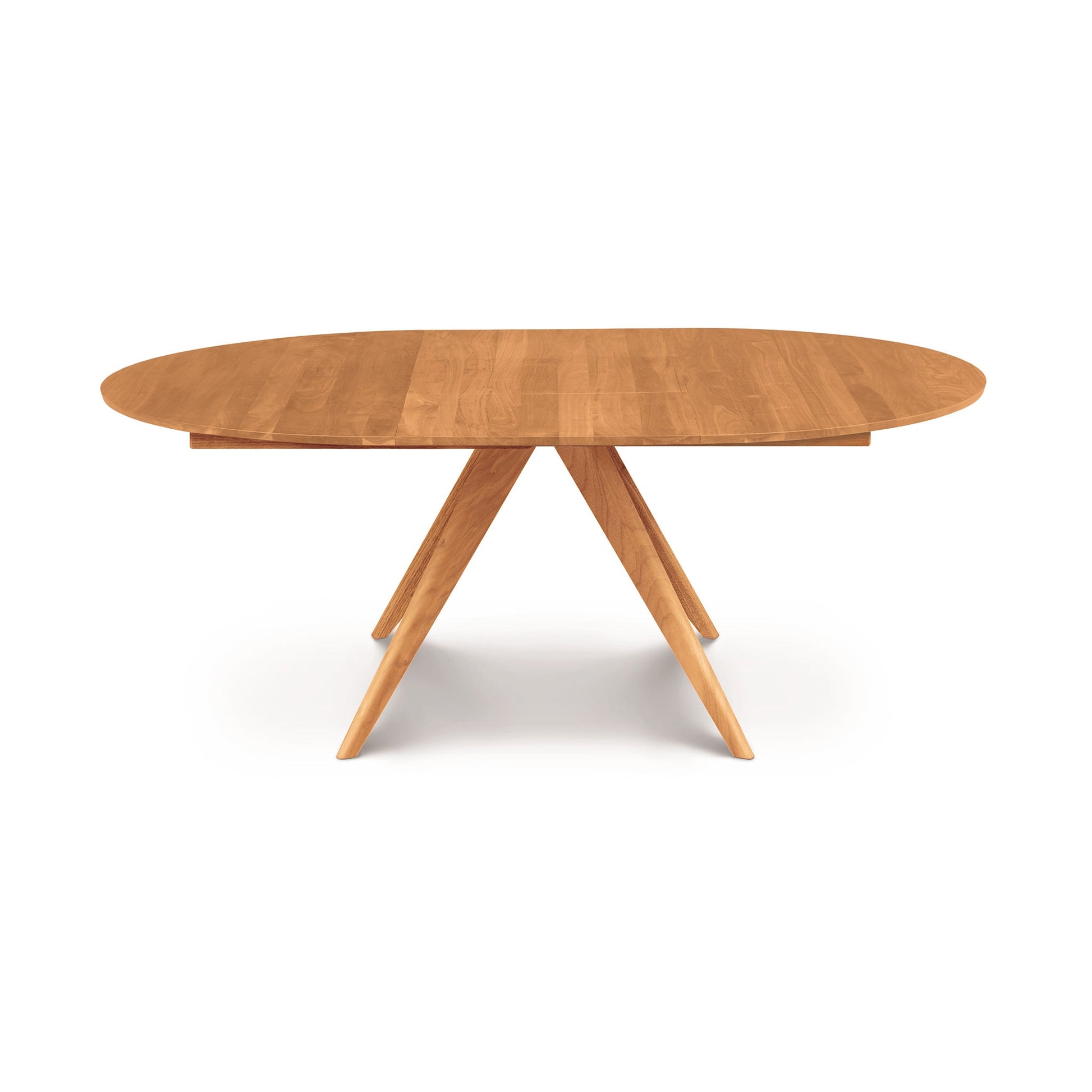 A wooden oval dining table with three legs.