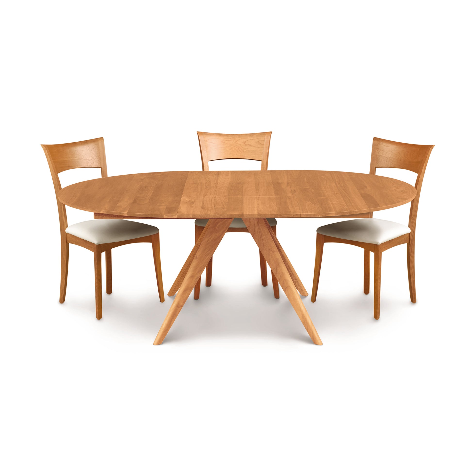 Copeland Catalina Round Extension Table with angled legs and three cushioned chairs, highlighting the modern wood furniture design.