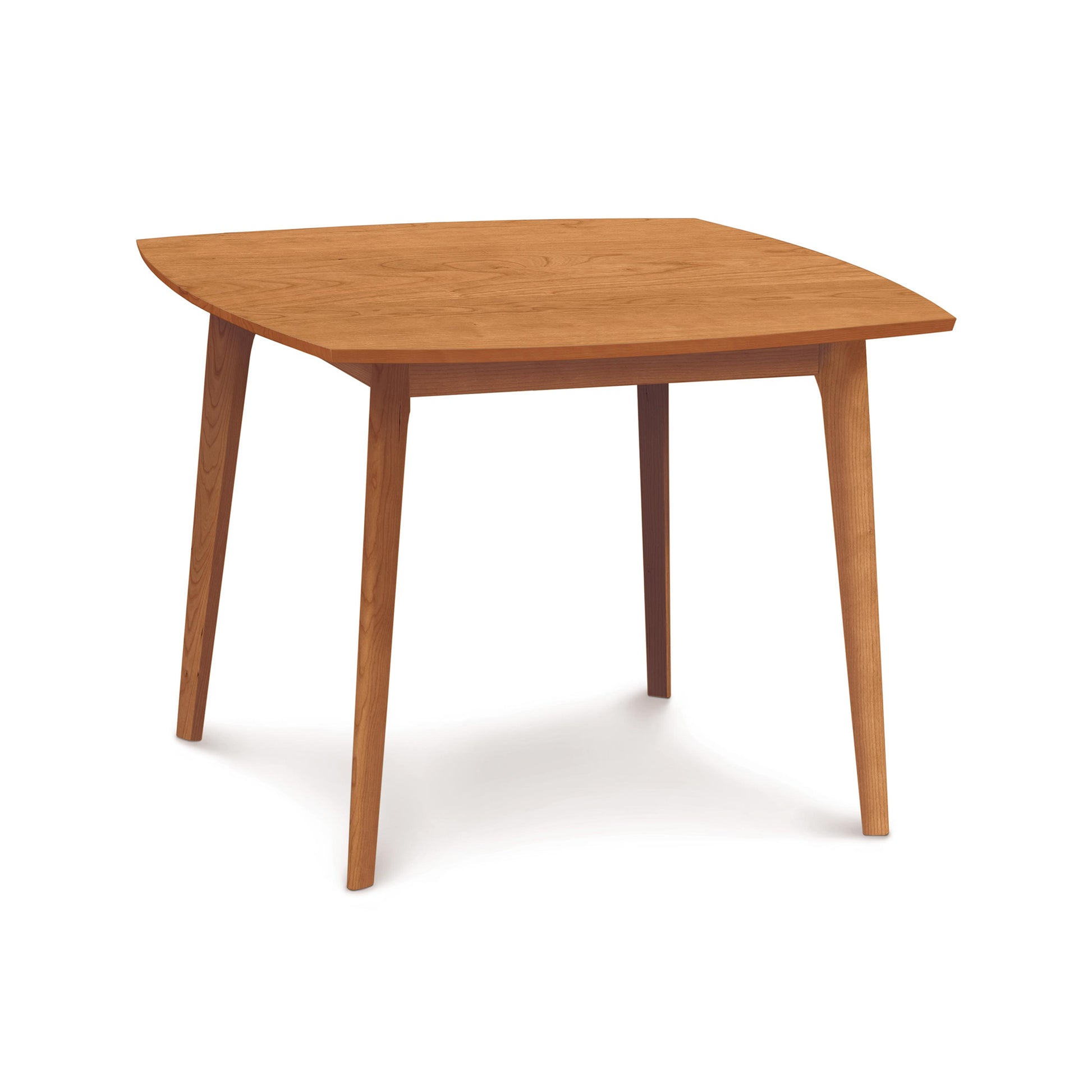 A Catalina Solid-Top Table by Copeland Furniture with sustainably-sourced hardwoods and four legs, featuring a rounded triangular top on a white background.