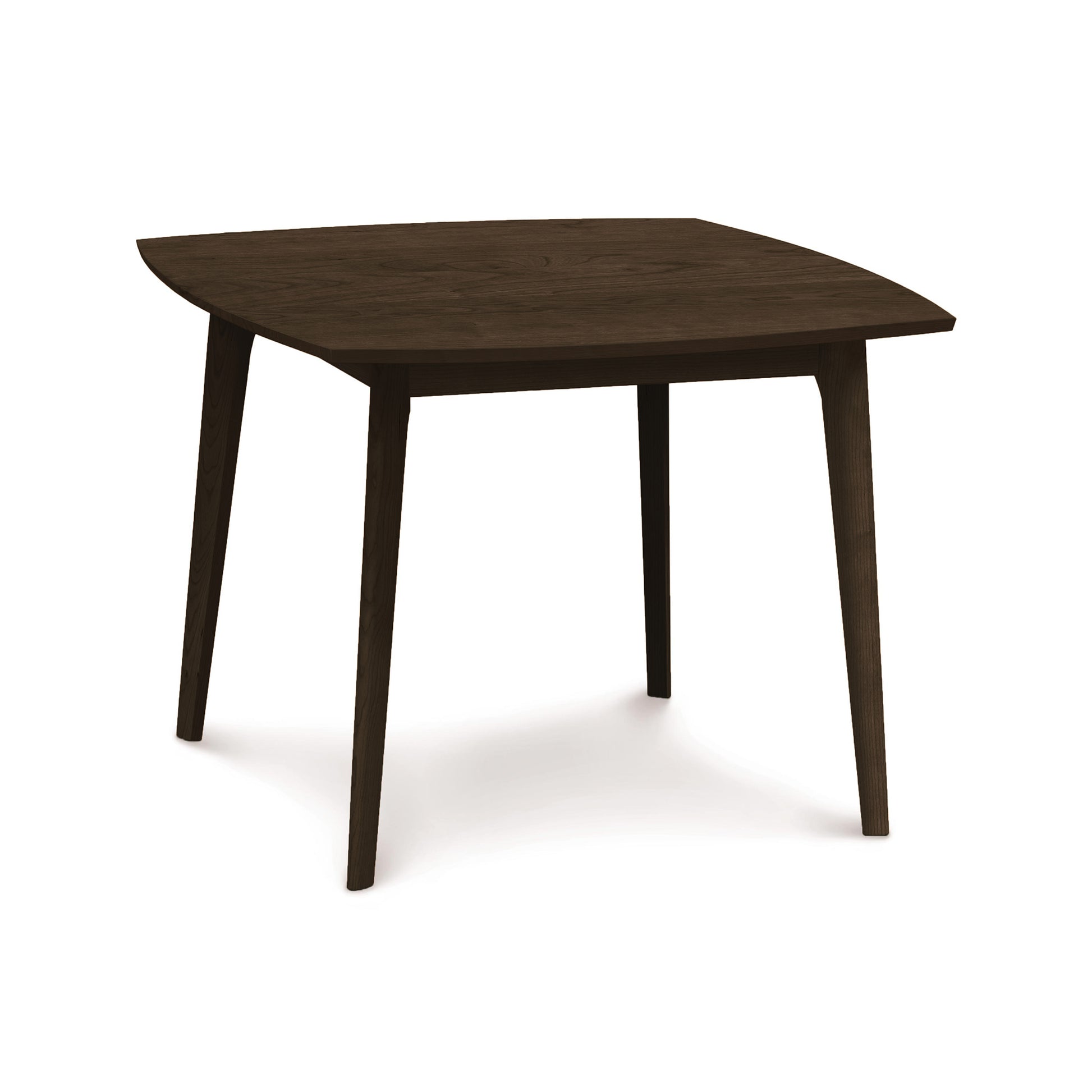 A solid wood Copeland Furniture Catalina Solid-Top Table with an asymmetrical hexagonal top and four legs against a white background, crafted from sustainably-sourced hardwoods.
