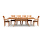 A solid American hardwood dining table set with six matching chairs on a plain white background, featuring the design of Copeland Furniture's Catalina Trestle Extension Table.