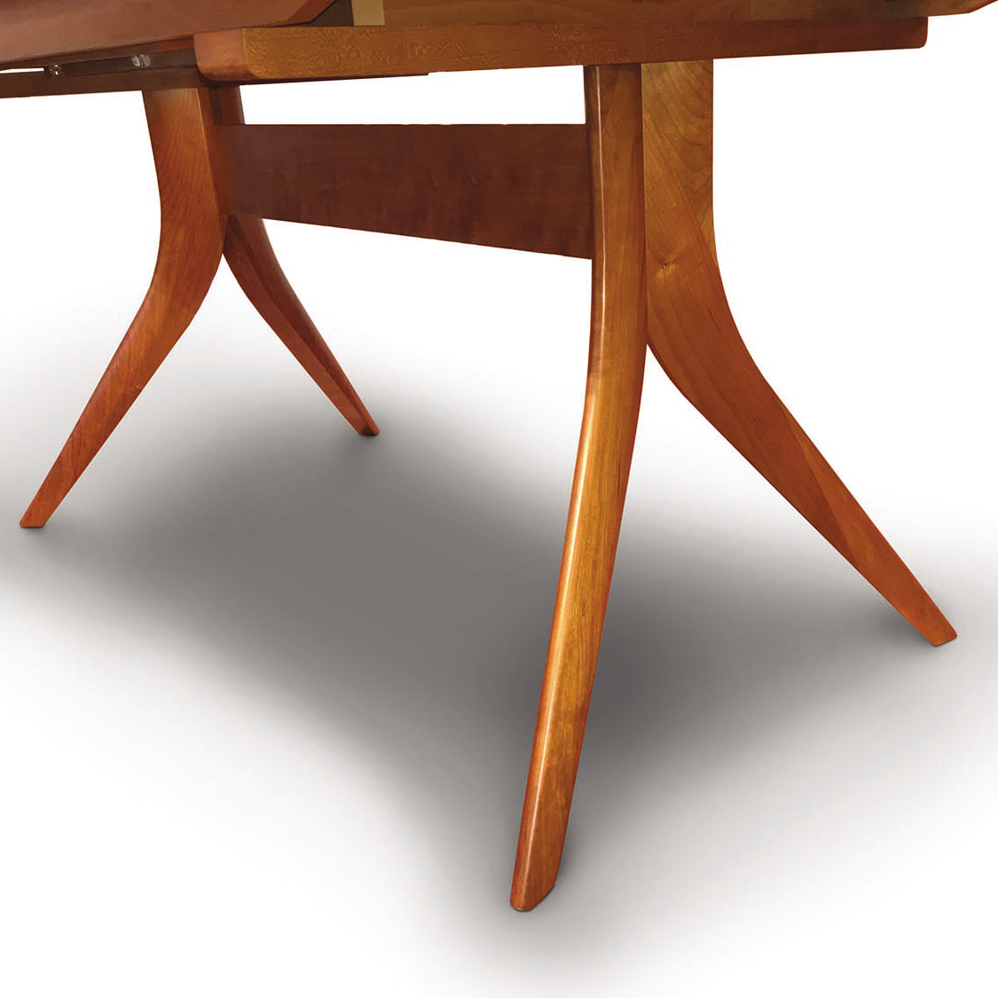Close-up of Copeland Catalina Trestle Extension Table legs crafted from solid American hardwood, highlighting the fine craftsmanship and wood grain.