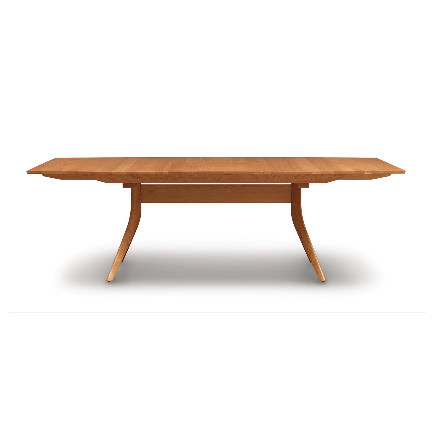 Copeland Furniture Catalina Trestle Extension Table with angular legs and an overhanging top, showcasing modern craftsmanship.