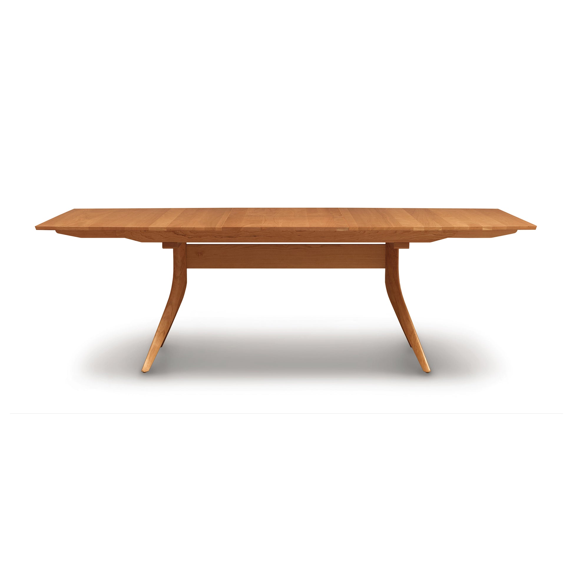Copeland Furniture Catalina Trestle Extension Table with angular legs and an overhanging top, showcasing modern craftsmanship.