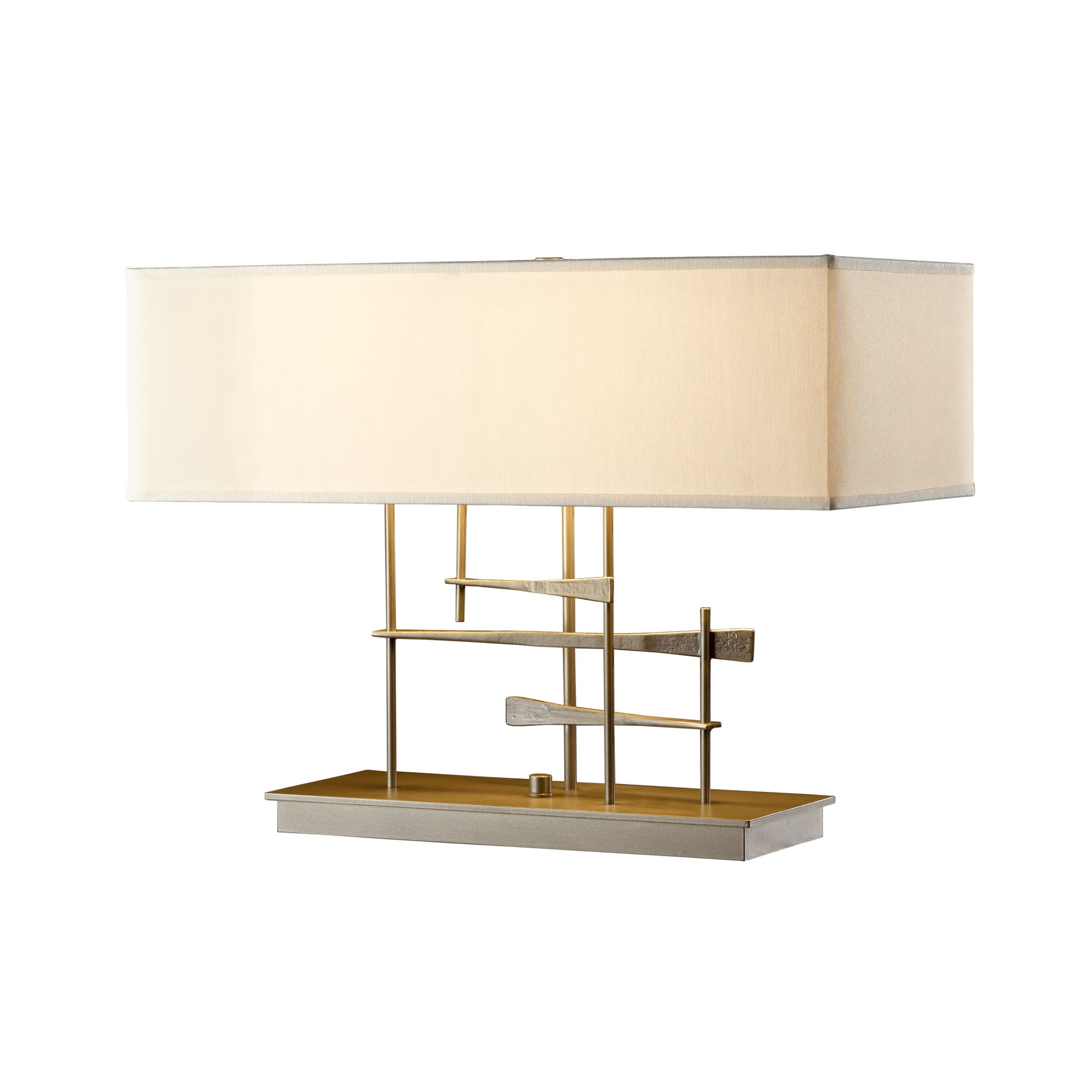 A contemporary Cavaletti Table Lamp by Hubbardton Forge with a rectangular beige shade, a hand-forged wrought iron frame, and a decorative horizontal element resembling a miniature staircase, positioned on a flat base.