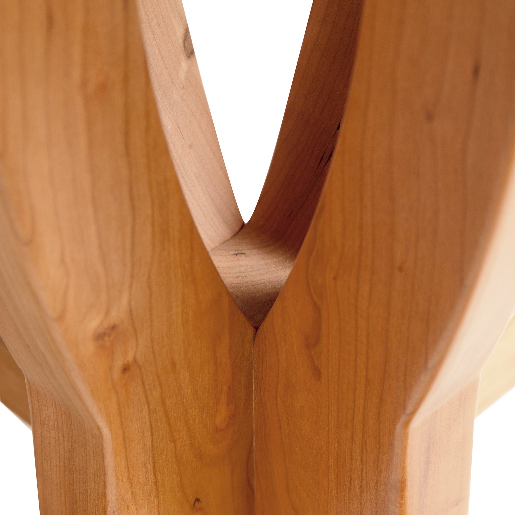 Detail of the V-shaped joint and polished cherry wood grain on Lyndon Furniture's Cherry Blossom Double Pedestal Extension Table.