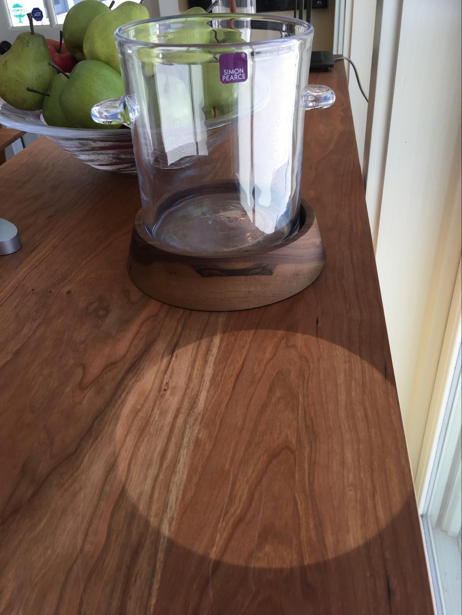 A bowl of apples on a wooden counter.