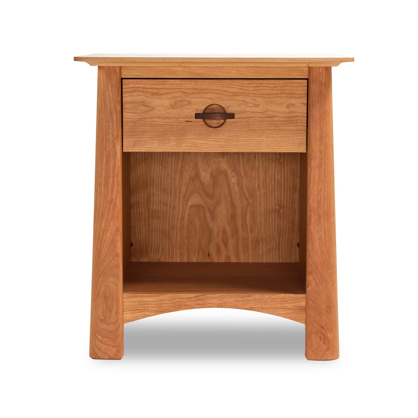 A Cherry Moon 1-Drawer Enclosed Shelf Nightstand by Maple Corner Woodworks features a single drawer with a round, metal handle and an open shelf below it. The sustainably harvested hardwoods nightstand is set against a white background and has a simple.