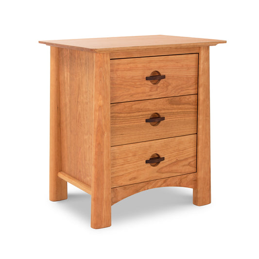A luxury Maple Corner Woodworks Cherry Moon 3-Drawer Nightstand with round handles and angled legs, isolated on a white background.