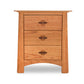 A wooden three-drawer bedside table with round metal handles, set against a white background. This Maple Corner Woodworks Luxury Cherry Moon 3-Drawer Nightstand features Vermont craftsmanship, delivering a simple yet sturdy design with slightly