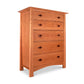 A Cherry Moon 5-Drawer Chest made of natural cherry wood, each drawer fitted with two round knobs. The chest stands against a white background.