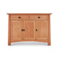 A Cherry Moon Medium Sideboard with two doors and one drawer, featuring black metal handles and a smooth finish from Maple Corner Woodworks, isolated on a white background.