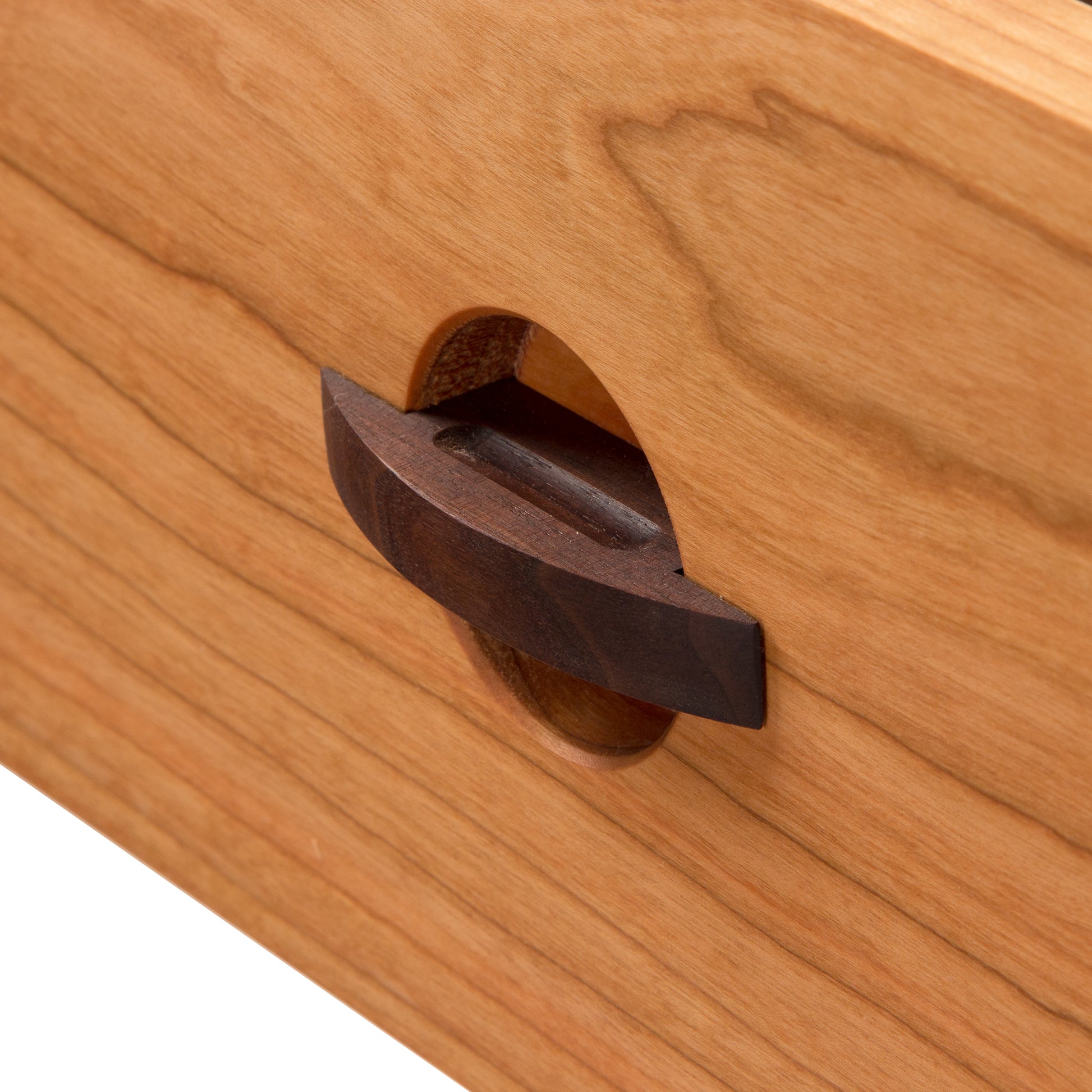 Cherry Moon 7-Drawer Dresser by Maple Corner Woodworks, with round handles in oval recesses, showcasing the natural grain and texture of sustainable wood and the elegance of eco-friendly furniture.