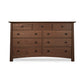 A Cherry Moon 9-Drawer Dresser from Maple Corner Woodworks, featuring a dark brown finish and round knobs, isolated on a white background. This eco-friendly dresser is perfect for sustainable homes.