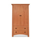 A Cherry Moon Armoire by Maple Corner Woodworks with two doors and three lower drawers, set against a plain white background. The armoire is crafted from light brown wood and features simple, black metal handles.
